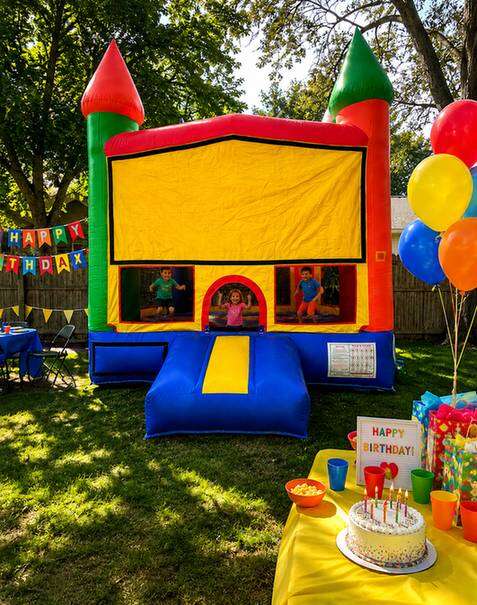 Bounce house rental delivered and set up in a standard DFW Texas backyard for a kids birthday party…