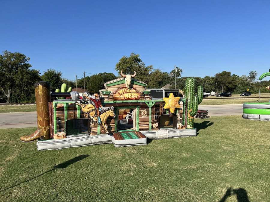 Wild West themed inflatable bounce house rental set up outdoors in Cleburne, TX