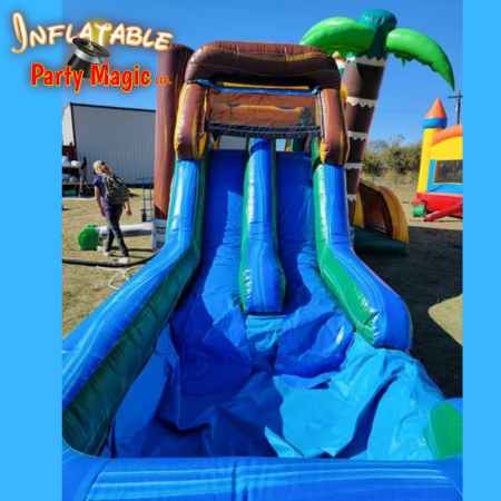 T-Rex Jurassic dinosaur bounce house double water slide combo rental side view showing bounce area a…