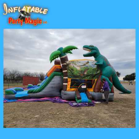 T-Rex Jurassic dinosaur bounce house water slide rental in action at a DFW Texas birthday party with…