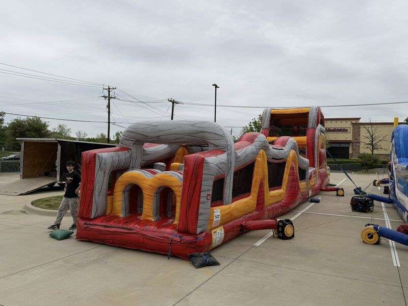 Red marble inflatable obstacle course rental from Inflatable Party Magic near Godley, TX