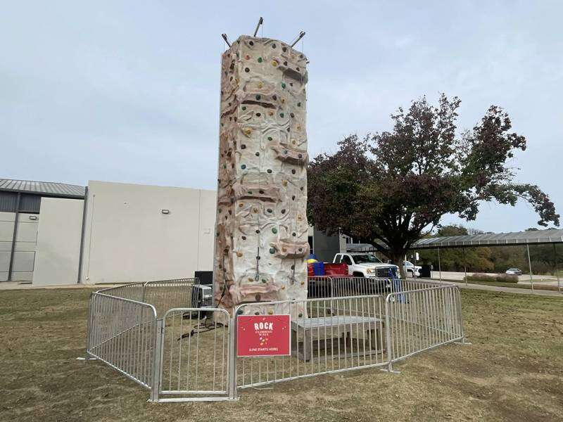Rock climbing wall rental at a Dallas Texas corporate event from Inflatable Party Magic with four st…