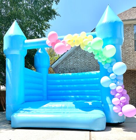 Pastel Blue Bounce House with Balloon Garland