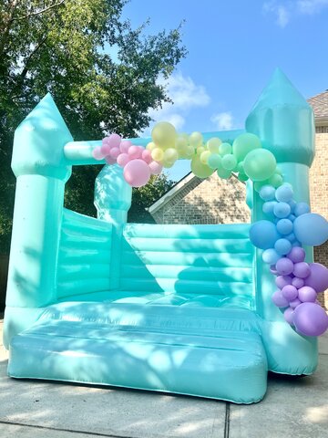 Pastel Green Bounce House with Balloon Garland