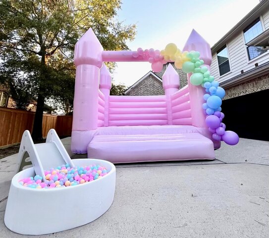 Pastel Pink Bounce House with Balloon Garland & Ball Pit