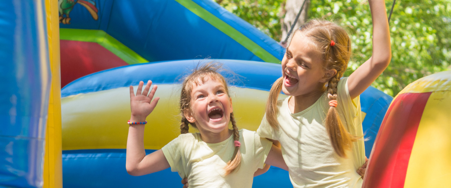 Kids smiling in bounce house in Houston, TX