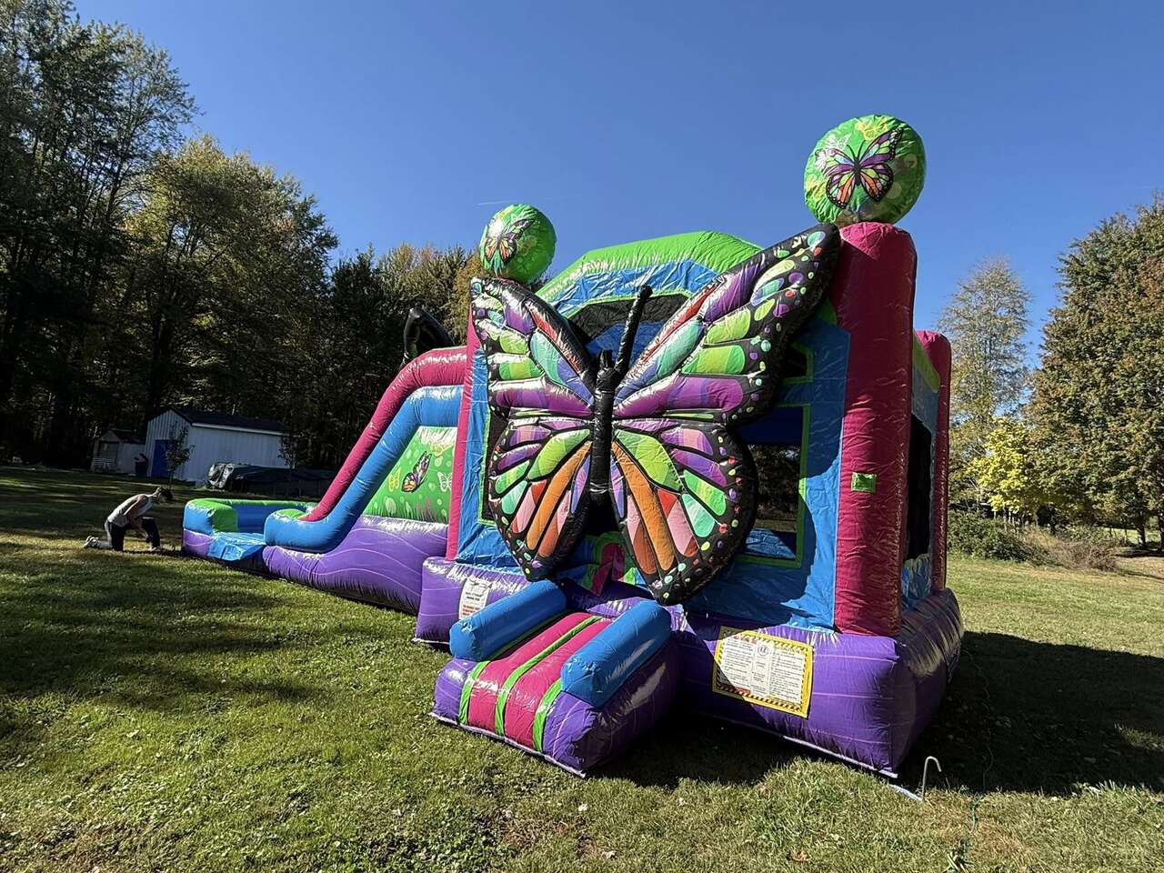 Colorful butterfly bounce house rental set up in Florence KY