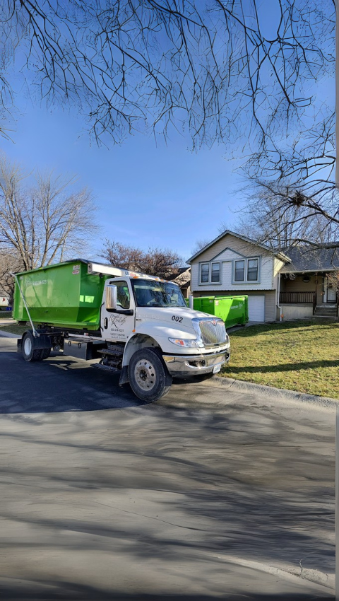 A Royal Rolloffs truck parked in front of a house A Royal Rolloffs truck parked in front of a house