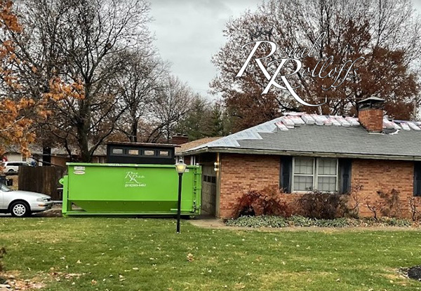 An assortment of green roll-off dumpsters lined up for rent by Royal Rolloffs, serving Kansas City and nearby areas.