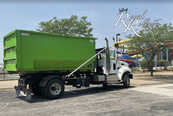 A close-up of a green roll-off dumpster showcasing Royal Rolloffs' quality offerings for customers in Kansas City and surrounding regions.