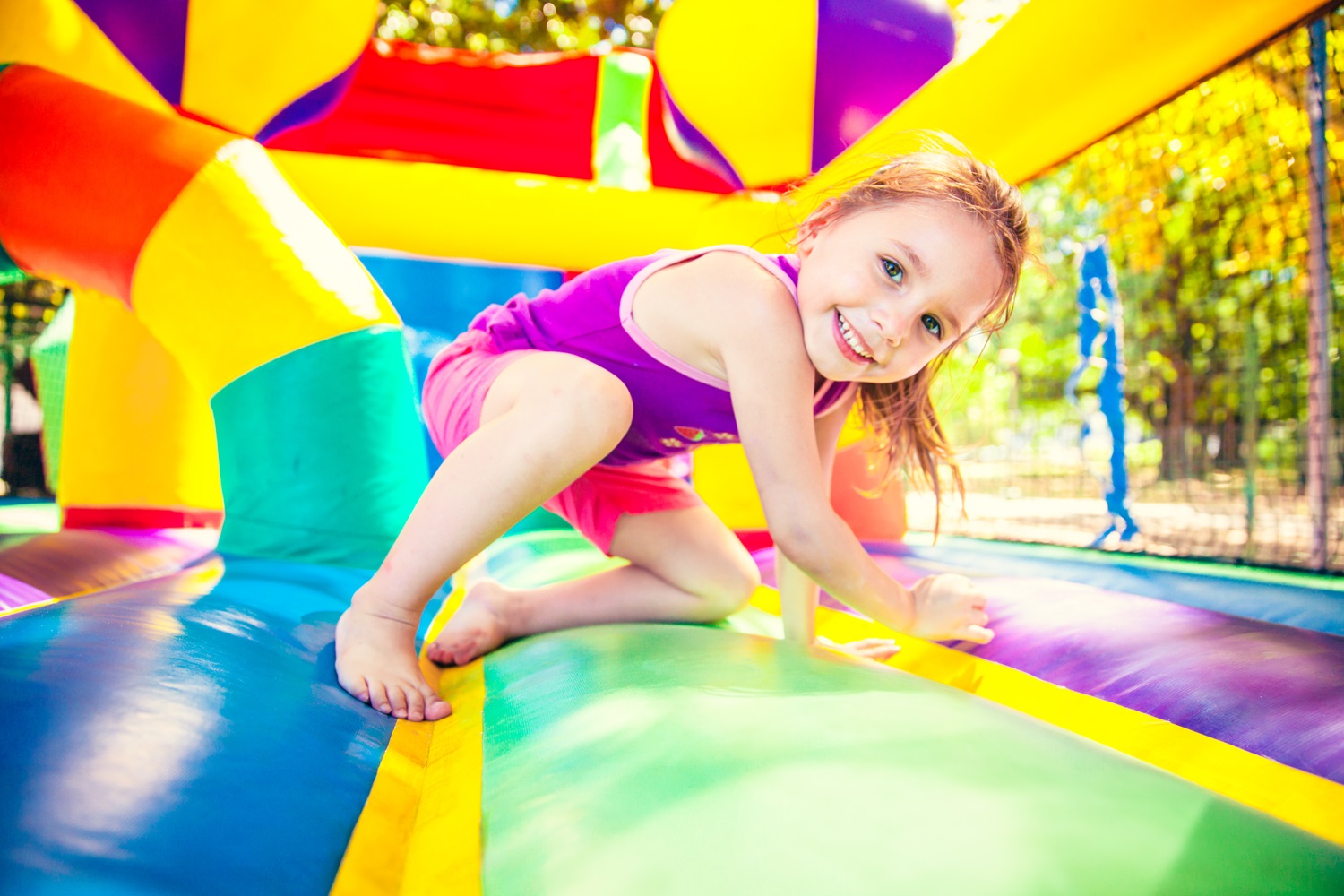 Smiling child playing in bounce house