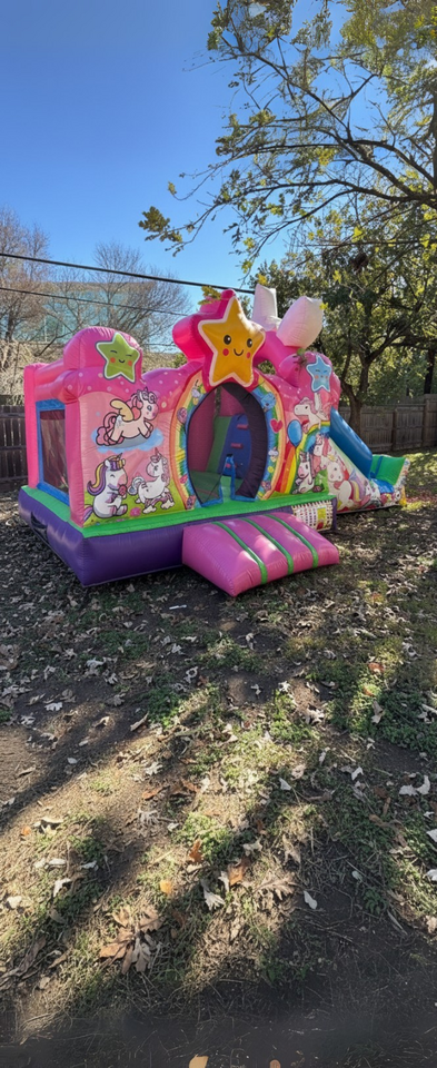 Pink unicorn combo bounce house with slide from Sandi's Moonwalks.