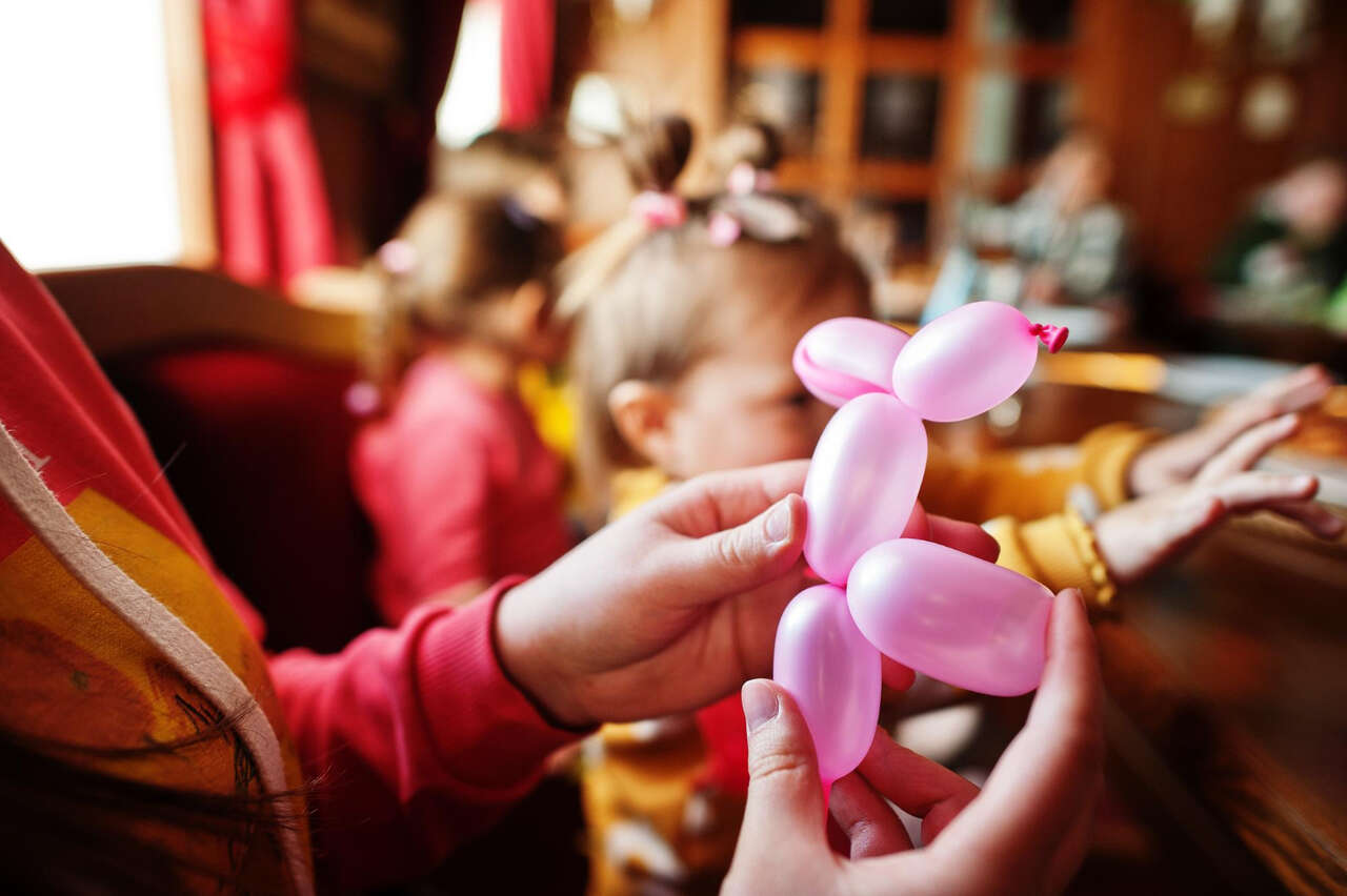 Person making a balloon dog Person making a balloon dog