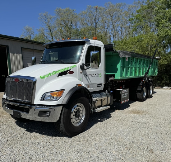Truck with green roll-off dumpster by Sparks Enterprises LLC Truck with green roll-off dumpster by Sparks Enterprises LLC