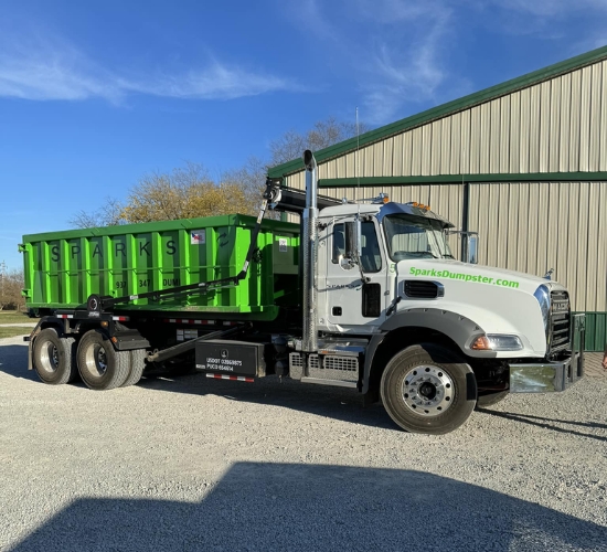 Truck with large green roll-off dumpster by Sparks Enterprises LLC Truck with large green roll-off dumpster by Sparks Enterprises LLC