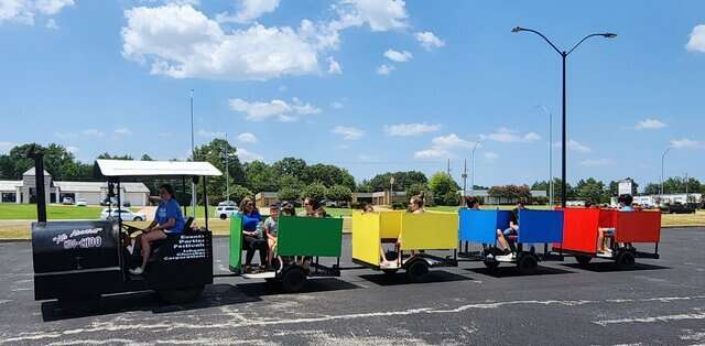 Kids riding a colorful trackless train rental in Marshall, TX