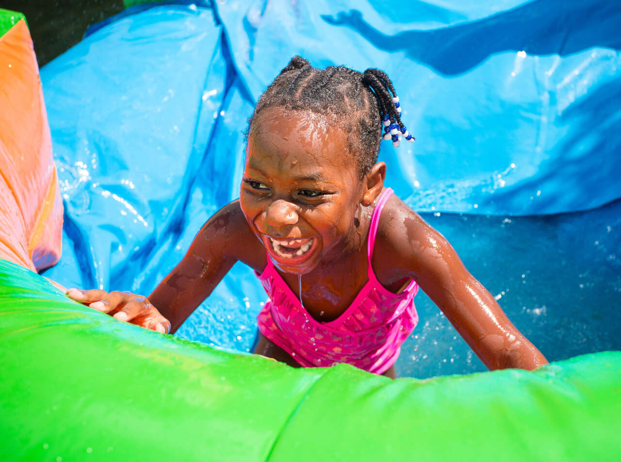 Kids playing on blue water slide combo rental at Adel Georgia summer party
