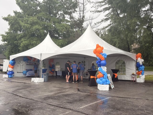ShipShape Party Rentals Lee's Summit ribbon cutting under white high peak tents with balloon columns