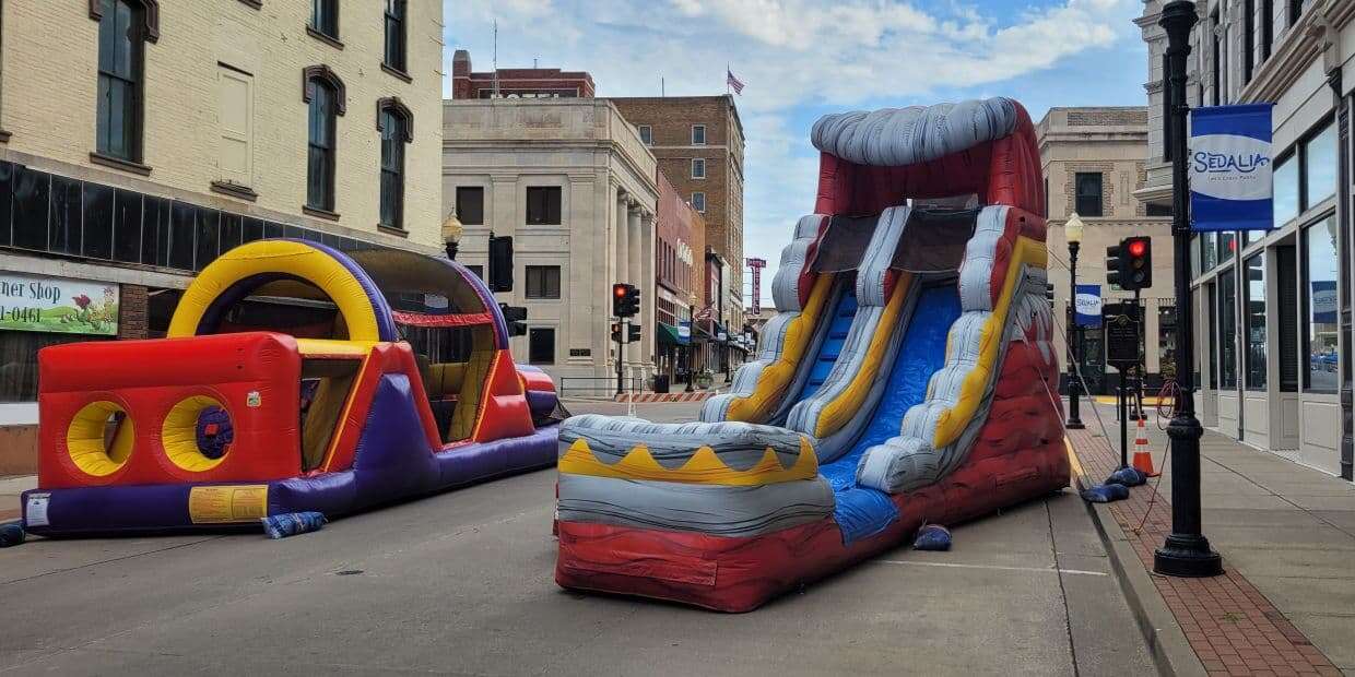 inflatable water slide downtown Sedalia on street with buildings