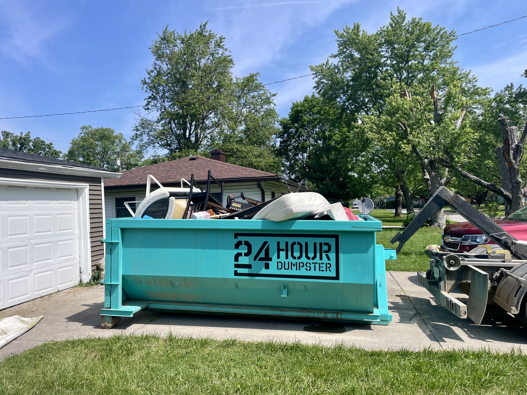 24 Hour Dumpster residential bin filled with household junk 24 Hour Dumpster residential bin filled with household junk