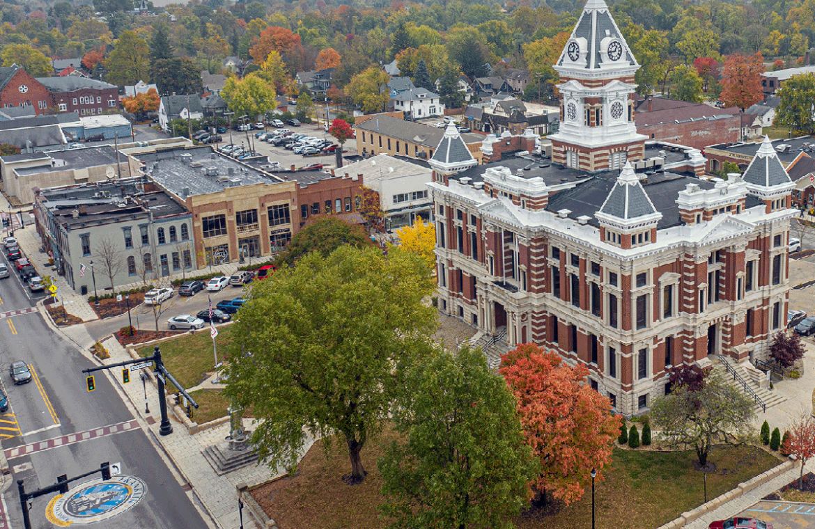 Historic courthouse in downtown square surrounded by fall trees
