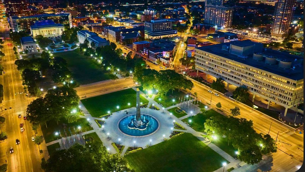 Downtown cityscape with illuminated monument and streets