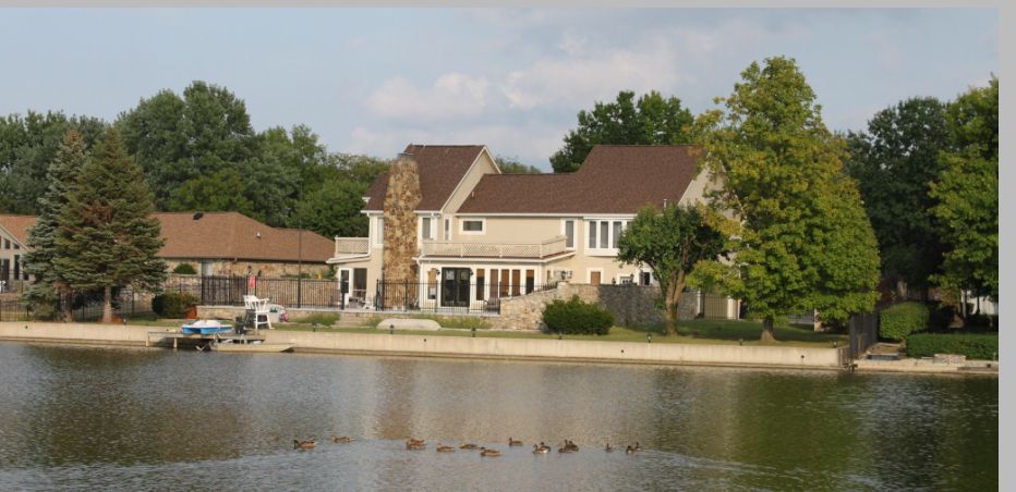 Luxury lakefront home with stone chimney and private dock