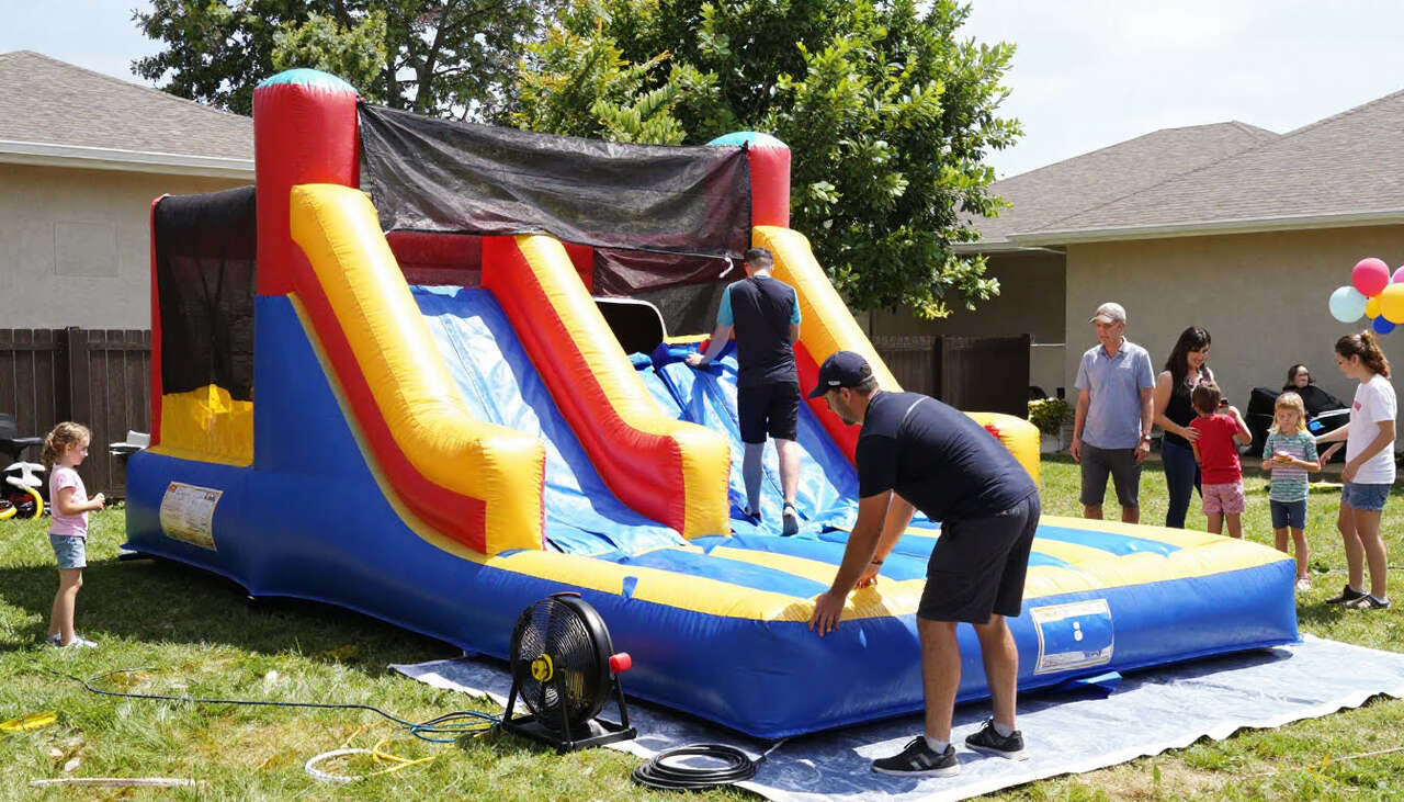 inflatable bounce house being inflated during installation