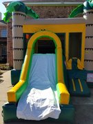<p>(#30) Palm bounce house with slide</p>