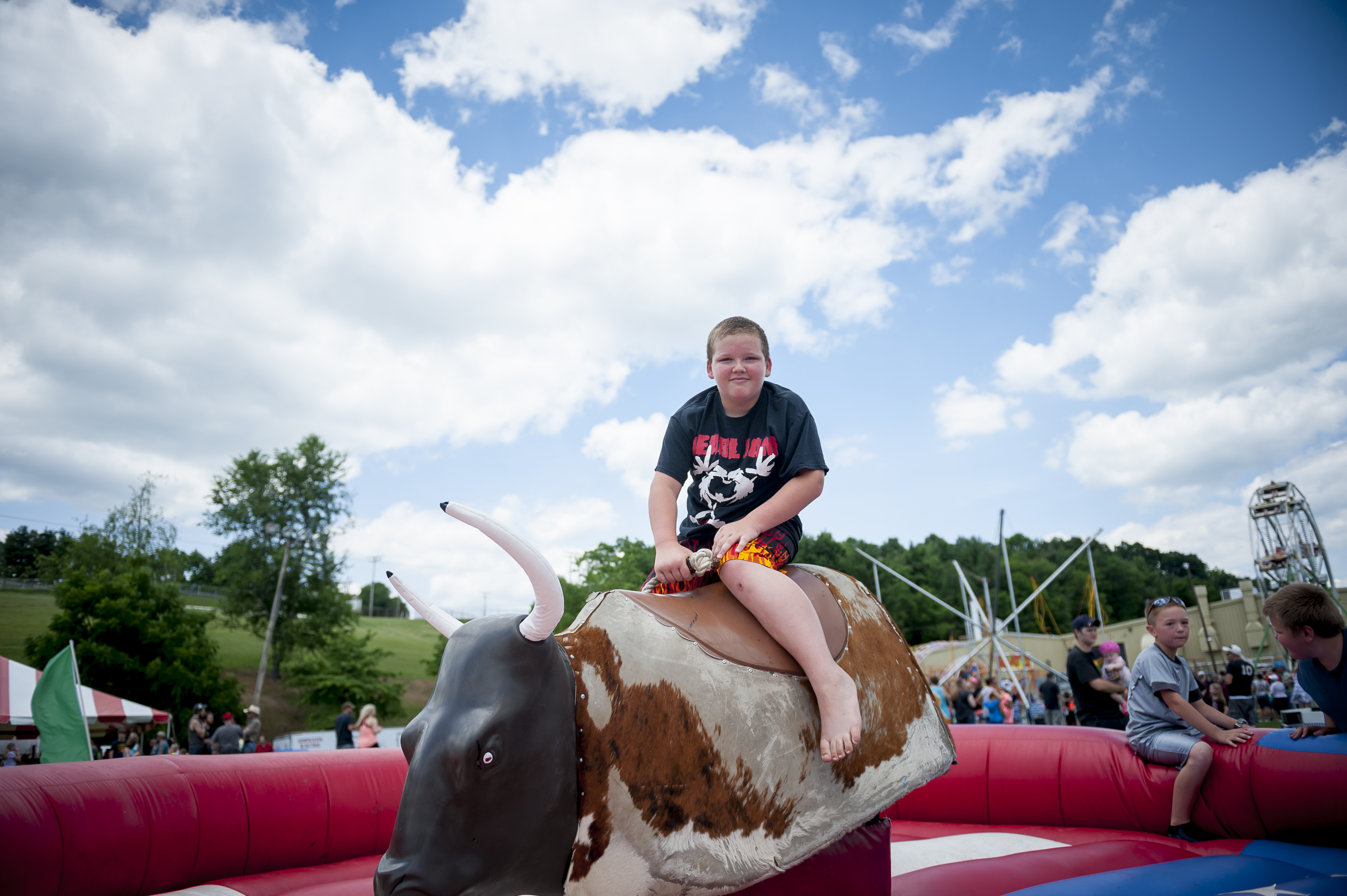 Child riding a mechanical bull at a party event Child riding a mechanical bull at a party event