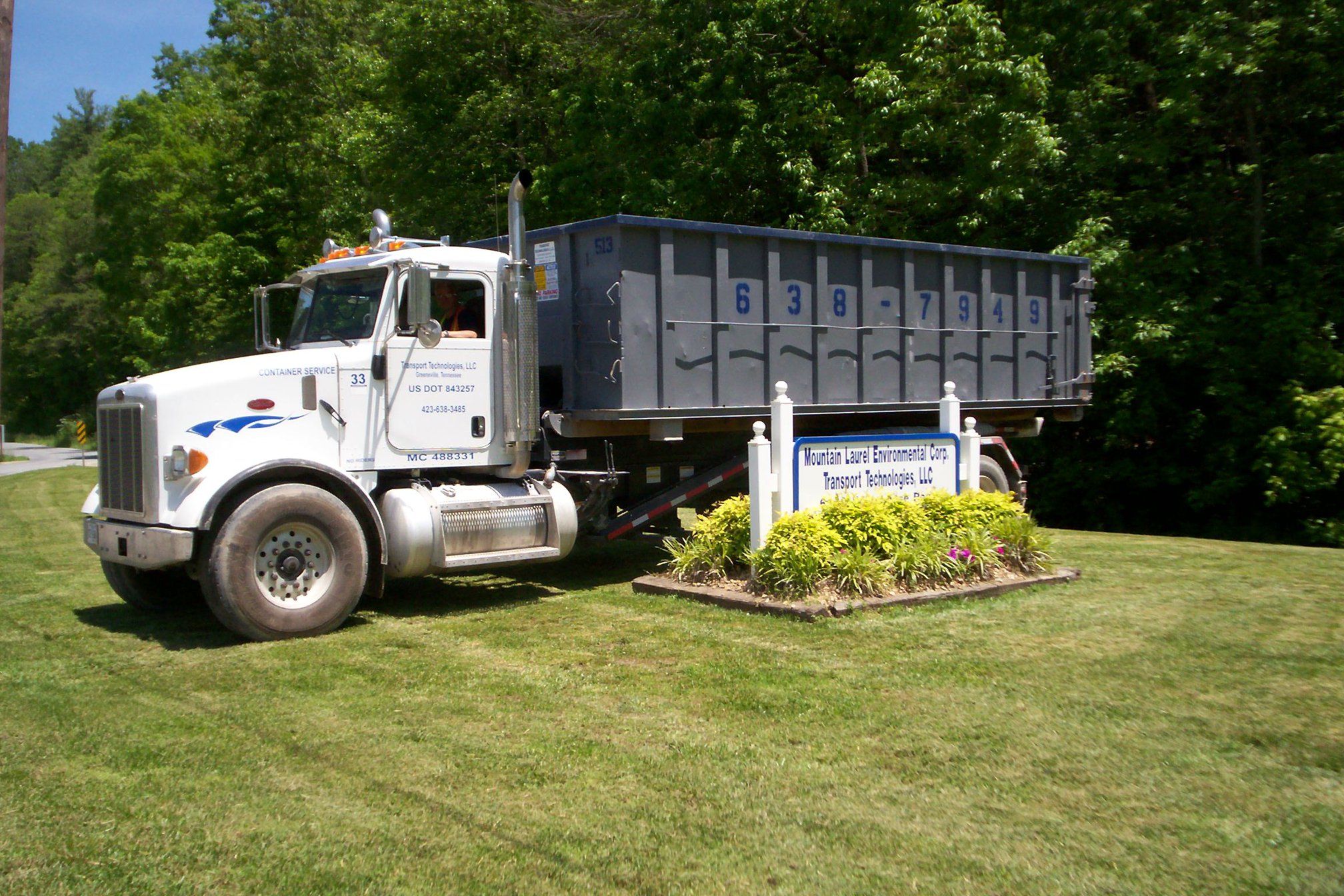 Dumpster rental truck near a commercial building Dumpster rental truck near a commercial building