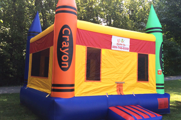 Crayon bouncy castle rental set up outside