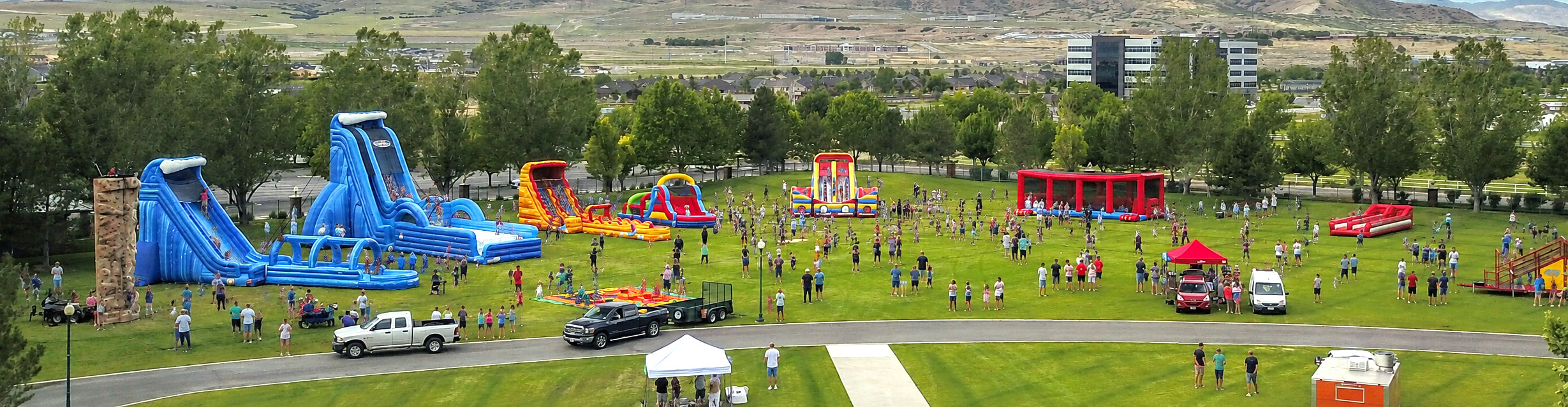 Large corporate, college, school and church event with inflatable slides, obstacle courses and interactive attractions from Utah Inflatables