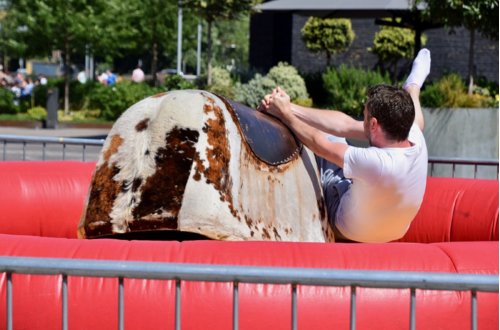 Vertical Entertainment mechanical bull ride rental with participant falling off during event. Vertical Entertainment mechanical bull ride rental with participant falling off during event.