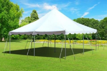 Large white outdoor event tent set up on a grassy field by Vertical Entertainment.