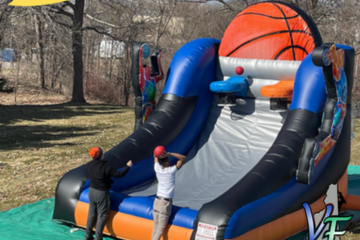 Inflatable basketball shooting game with two players competing, provided by Vertical Entertainment.