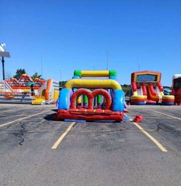 Vertical Entertainment inflatable bounce house and water slide setup in outdoor