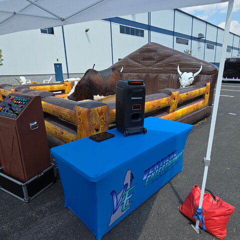 Mechanical bull rental with inflatable safety arena set up for a party in New Hampshire by Vertical Entertainment