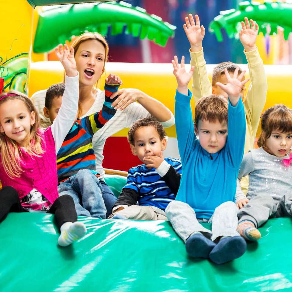 Children's Party Rentals made easy with We Bring the Party showing kids on an inflatable slide Children's Party Rentals made easy with We Bring the Party showing kids on an inflatable slide