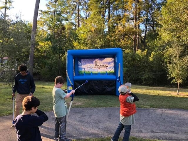 Guests taking turns at an inflatable target game at an outdoor Xtreme event