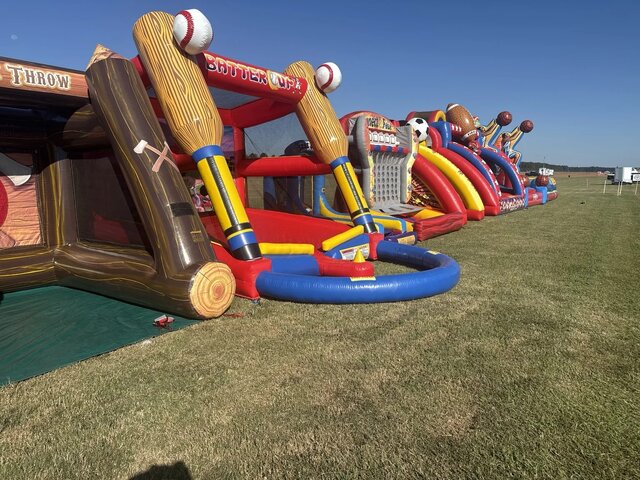 A wide lineup of Xtreme inflatable sports and interactive games at an event