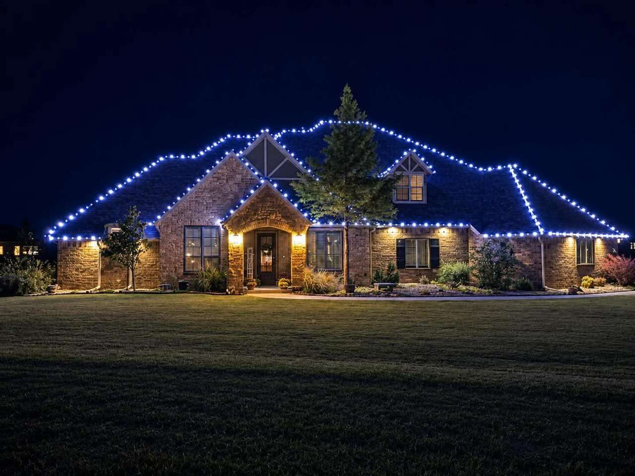 Blue roofline lights on a stone house