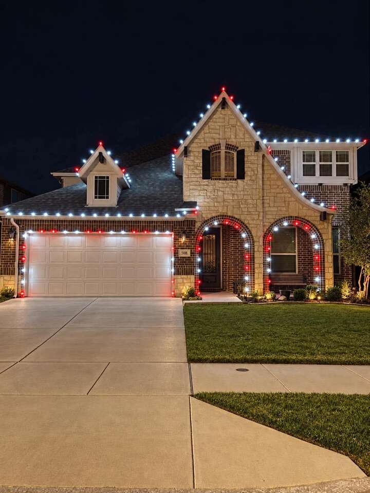 Red and white lights around a garage and arches